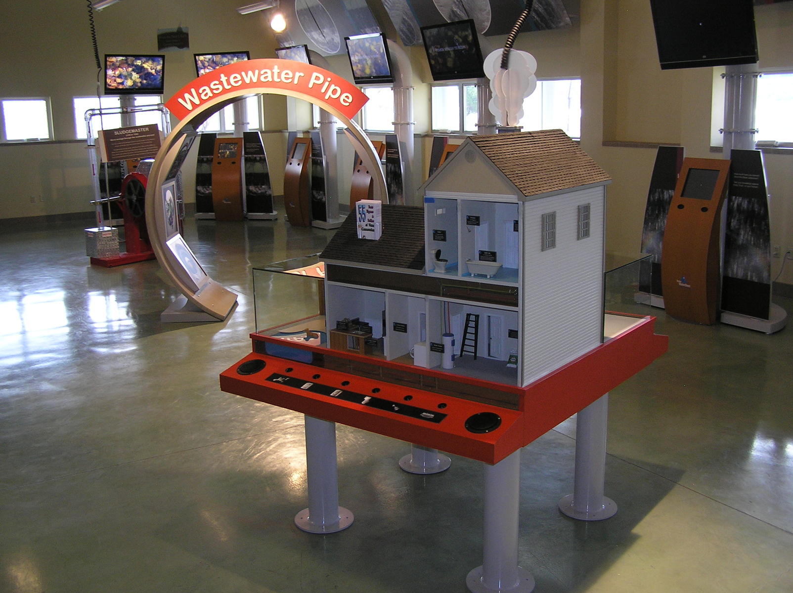 This is an educational exhibit built at Boise's water treatment plant. The model house was completely custom made by me. It has asphalt shingles and five rooms illustrating where and how water is used in the home. Its hard to see in the picture but each button on the desk corresponds with led lighting that tracks the path of water throughout the home to each function. There are also sound effects with each function. In the background is an archway I made from an actual waste water pipe.